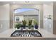 Modern kitchen cooktop with quartz counters, view of the backyard, and beautiful tile backsplash at 20503 E 50Th Pl, Denver, CO 80249