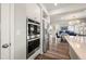 Stainless steel appliances in the kitchen complement the wood flooring and open floor plan at 20503 E 50Th Pl, Denver, CO 80249
