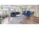 Bright living room featuring hardwood floors, a large window and blue accents at 20503 E 50Th Pl, Denver, CO 80249