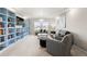 Cozy living room with built-in bookshelves, plush seating, and ample natural light at 20503 E 50Th Pl, Denver, CO 80249