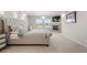 Well-lit main bedroom showcasing a tufted bed, fireplace, and large windows with neighborhood views at 20503 E 50Th Pl, Denver, CO 80249