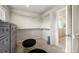 Large walk-in closet with custom shelving, dual ottomans, and access to main bathroom at 20503 E 50Th Pl, Denver, CO 80249