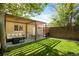 Private backyard oasis with a patio, seating area, and a spacious, green lawn at 3929 Shoshone St, Denver, CO 80211