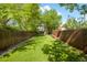 Expansive backyard enclosed by wooden fencing, offering a large, grassy area at 3929 Shoshone St, Denver, CO 80211