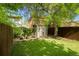Spacious backyard featuring a storage shed, mature trees, and a lush green lawn at 3929 Shoshone St, Denver, CO 80211
