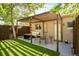 Charming backyard with a covered patio, outdoor seating, and well-maintained lawn at 3929 Shoshone St, Denver, CO 80211