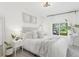Bright bedroom features neutral tones, large window, and comfortable furnishings at 3929 Shoshone St, Denver, CO 80211