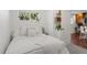 Cozy bedroom featuring a bed with all-white bedding, natural light, and decor accents at 3929 Shoshone St, Denver, CO 80211