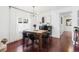 Bright dining area with wooden table, modern light fixture, and dark floors at 3929 Shoshone St, Denver, CO 80211