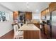 Updated kitchen features granite counters, stainless appliances, and breakfast bar seating at 3929 Shoshone St, Denver, CO 80211
