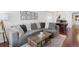 Stylish living area showcasing a sectional sofa, rustic coffee table, and modern decor at 3929 Shoshone St, Denver, CO 80211