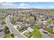 Expansive aerial view of a residential neighborhood with beautiful mountain views and lush green landscape in the background at 8209 Benton Way, Arvada, CO 80003