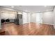 Open basement design with laundry, kitchen appliances, and sleek wood flooring at 8209 Benton Way, Arvada, CO 80003