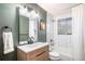 Bright bathroom with a modern vanity, subway tile, and updated fixtures at 8209 Benton Way, Arvada, CO 80003