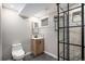 Modern bathroom featuring a tiled shower, stylish vanity, and contemporary fixtures at 8209 Benton Way, Arvada, CO 80003