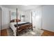 Cozy bedroom with a four-poster bed, soft lighting, and sheer white curtains at 8209 Benton Way, Arvada, CO 80003