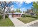 Charming brick home with a well-manicured lawn, mature trees, and attached garage, offering great curb appeal at 8209 Benton Way, Arvada, CO 80003