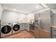 Basement kitchenette featuring stainless steel appliances, marble backsplash, and wood countertops at 8209 Benton Way, Arvada, CO 80003