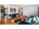 Stylish living room with hardwood floors, blue chairs and couch, and a unique animal hide rug at 8209 Benton Way, Arvada, CO 80003