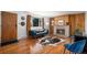 Inviting living room featuring a cozy fireplace, hardwood floors, and a comfortable blue velvet sofa at 8209 Benton Way, Arvada, CO 80003