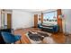 Comfortable living room with hardwood floors, blue velvet sofa, and bright natural light at 8209 Benton Way, Arvada, CO 80003