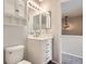 This bathroom features a vanity sink, a mirror and cabinet, and a toilet at 164 Bristlecone St, Brighton, CO 80601