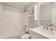 Updated bathroom with white vanity and shower/tub combo at 164 Bristlecone St, Brighton, CO 80601