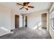 Well-lit bedroom with ceiling fan and private bathroom access at 164 Bristlecone St, Brighton, CO 80601