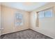 Charming bedroom with two windows and carpet flooring at 164 Bristlecone St, Brighton, CO 80601