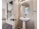 This powder room features a pedestal sink, and a large mirror at 164 Bristlecone St, Brighton, CO 80601