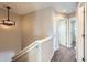 Upstairs hallway with access to bedrooms and bathroom at 164 Bristlecone St, Brighton, CO 80601