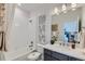 Clean, bright bathroom featuring a shower over tub and stylish vanity at 12762 Bend Ct, Firestone, CO 80504