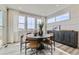 Bright dining area with ample natural light, round table, and stylish modern buffet at 12762 Bend Ct, Firestone, CO 80504