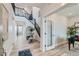 Bright entryway features a soaring ceiling, hardwood floors, decorative table, and an open staircase at 12762 Bend Ct, Firestone, CO 80504