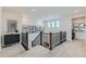 Hallway with dark railings and neutral-colored carpet and walls at 12762 Bend Ct, Firestone, CO 80504