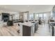 Open concept kitchen with island seating, stainless appliances, and seamless flow to the living area at 12762 Bend Ct, Firestone, CO 80504