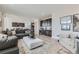 Open-concept living area showcasing a kitchen with dark wood cabinetry, seating, and an elegant bar area at 12762 Bend Ct, Firestone, CO 80504