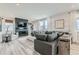 Inviting living room featuring a modern fireplace, comfortable seating, and abundant natural light at 12762 Bend Ct, Firestone, CO 80504