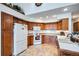 Functional kitchen boasts wood cabinets, white appliances, and ample counter space at 19 Carla Way, Broomfield, CO 80020