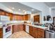 Cozy kitchen features wooden cabinets and tile flooring with a view into the living room at 19 Carla Way, Broomfield, CO 80020