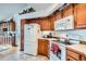Cozy kitchen featuring wooden cabinets, white appliances, and decor accents at 19 Carla Way, Broomfield, CO 80020