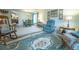 Comfortable living area connects to the dining room and features a rocking chair and recliner at 19 Carla Way, Broomfield, CO 80020