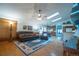 Bright living room features hardwood floors, a ceiling fan, skylights and opens to the kitchen at 19 Carla Way, Broomfield, CO 80020