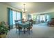 Open floorplan connects the dining room to the living room with large windows at 19 Carla Way, Broomfield, CO 80020