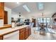 Open concept living area with skylights, hardwood floors, and a dining set at 19 Carla Way, Broomfield, CO 80020