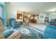 Open living area with a rocking chair and several recliners on a decorative rug at 19 Carla Way, Broomfield, CO 80020