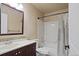 Bathroom featuring dark vanity, white tile, and shower over tub at 708 S Carlton St, Castle Rock, CO 80104