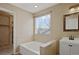 Bright bathroom features tiled walls surrounding the bathtub, a sink and storage at 708 S Carlton St, Castle Rock, CO 80104