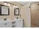 Bathroom featuring double sinks, framed mirrors, a shower and tile floor at 708 S Carlton St, Castle Rock, CO 80104