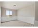 Well-lit bedroom featuring updated paneling, plush carpet, and a large window at 708 S Carlton St, Castle Rock, CO 80104